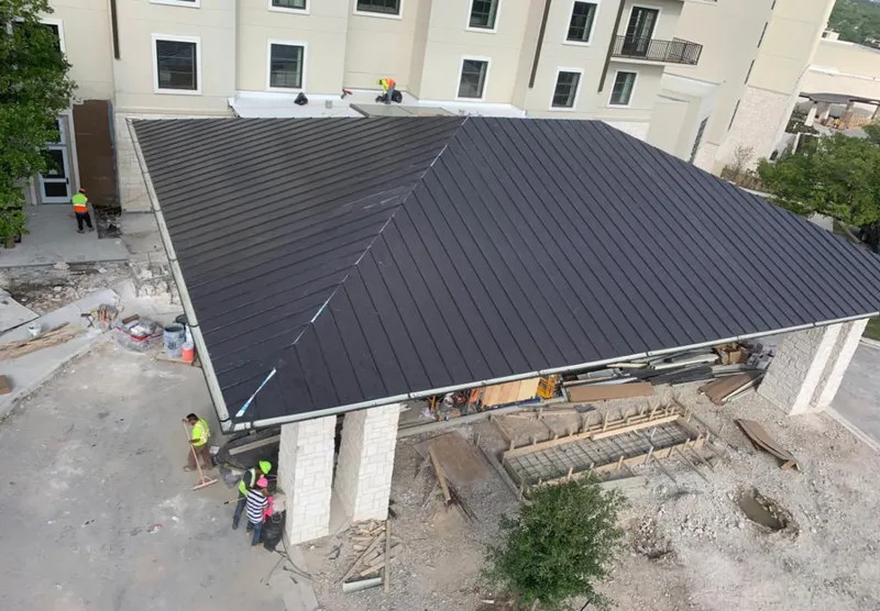 Metal roofing installation team working on a commercial building in Minot