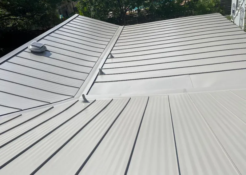 Solar attic fan installed on a metal roof for Roof Ventilation in Minot